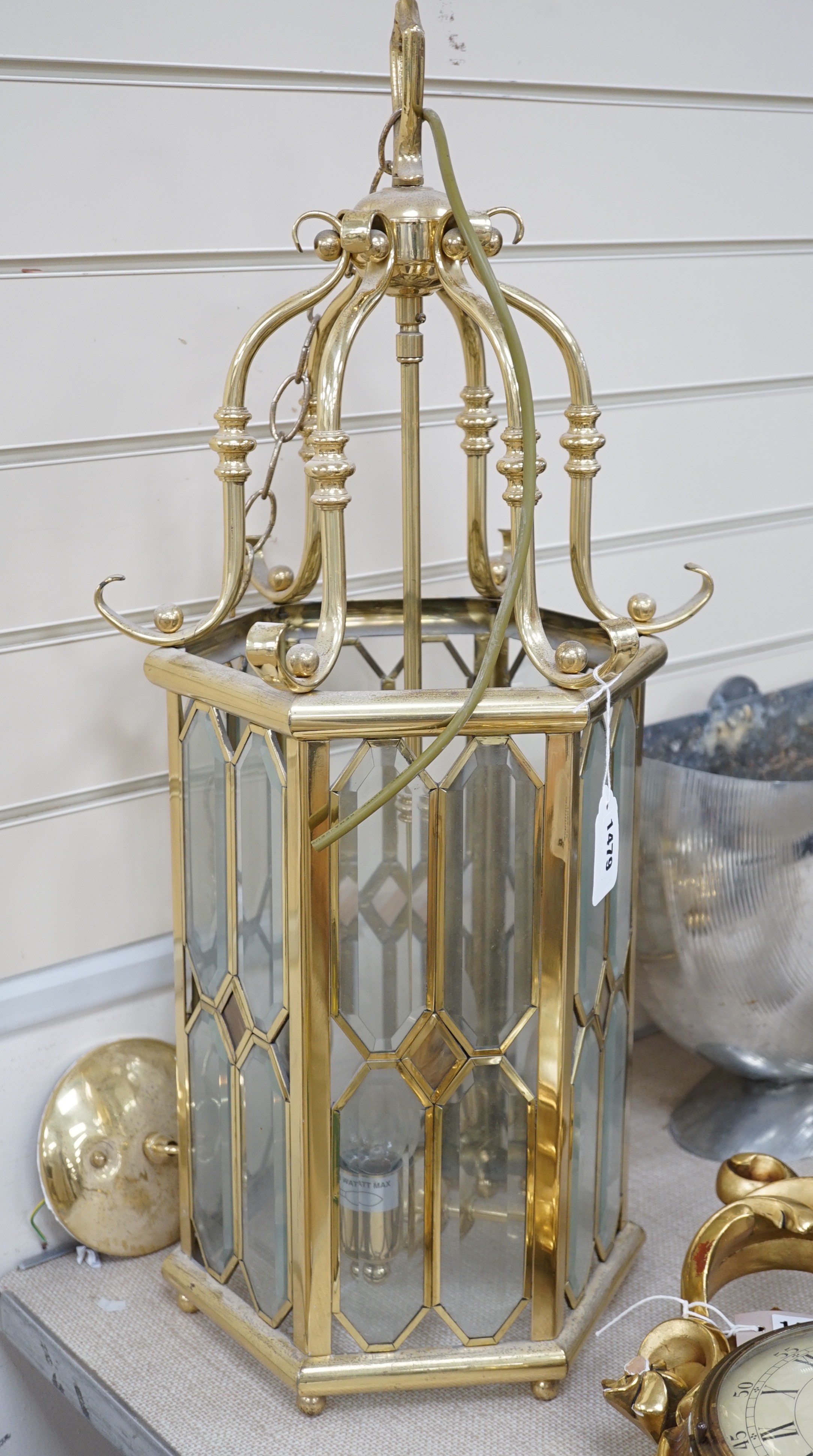 A hexagonal brass and bevelled glass hall lantern, 70 cms high